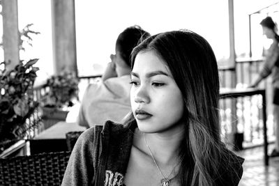 Close-up portrait of a young woman looking away