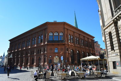 People at town square against clear sky