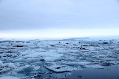 Scenic view of frozen landscape against sky