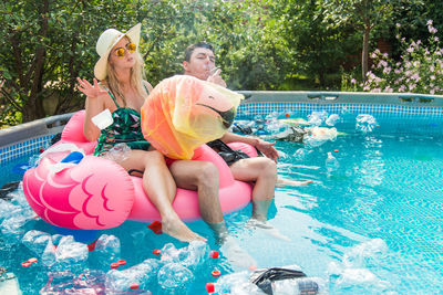 Woman sitting in swimming pool