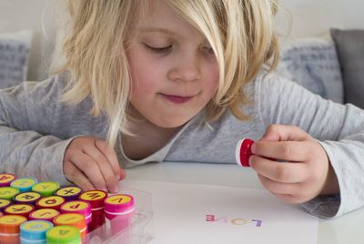 Close-up of cute girl holding stamp