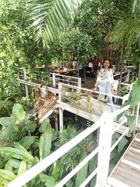 Woman standing by plants