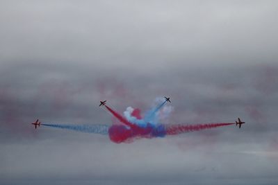 Airplane flying over cloudy sky