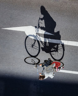 High angle view of man with bicycle on street