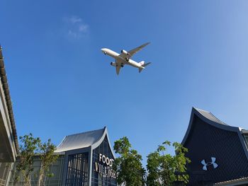 Low angle view of airplane flying against sky