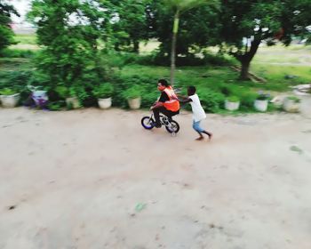 People riding motorcycle on road