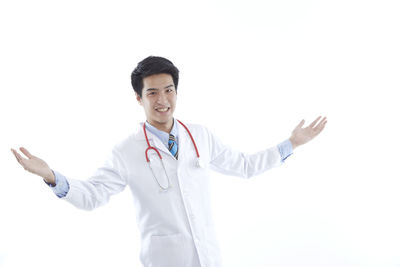 Young man standing against white background