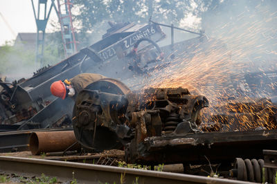 Worker welding by railroad track