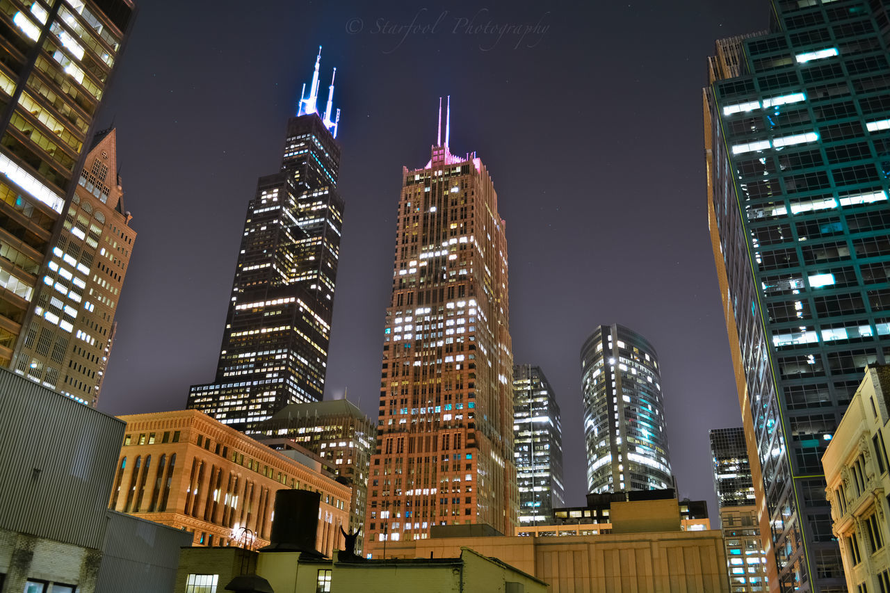 building exterior, architecture, built structure, city, illuminated, skyscraper, night, tall - high, tower, modern, office building, low angle view, cityscape, financial district, clear sky, capital cities, city life, building, tall, travel destinations