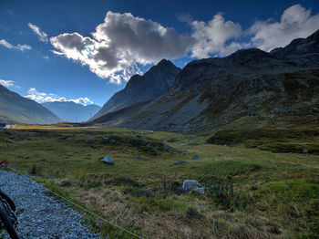 Scenic view of field and mountains against sky