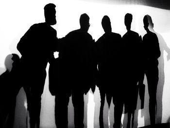 Silhouette people standing on floor