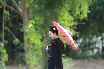 Side view of woman standing outdoors