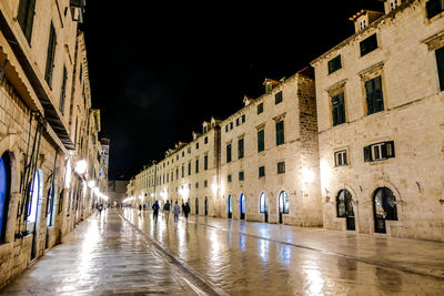 View of wet street at night