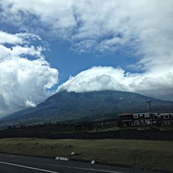 Scenic view of field against cloudy sky