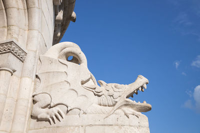 Low angle view of statue against blue sky