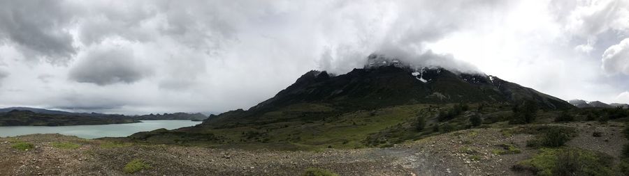 Scenic view of sea and mountains against sky
