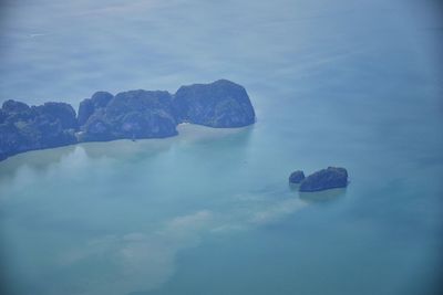 Rocks in sea against sky