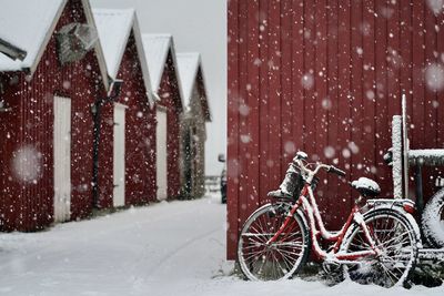 Bicycles in snow against building during winter