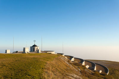 Built structure on land against clear blue sky