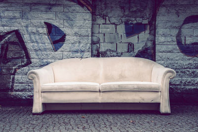 Close-up of sofa against wall