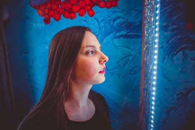 Portrait of beautiful young woman looking away