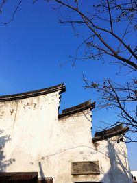 Low angle view of building against clear blue sky