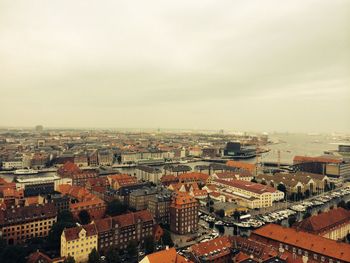 Cityscape against cloudy sky