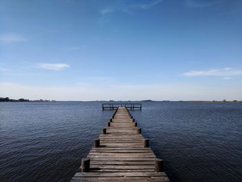 Pier over sea against sky