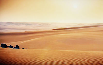 Scenic view of sandy beach at sunset