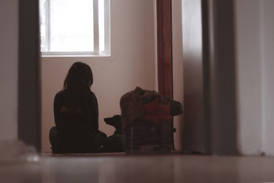 Man looking through window