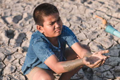 Boy playing on sand at beach