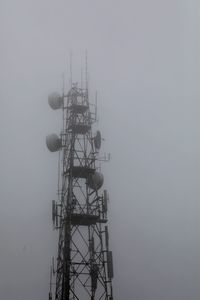 Low angle view of communications tower against sky