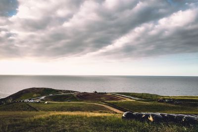 Scenic view of sea against cloudy sky