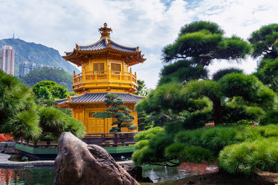 Temple by building against sky