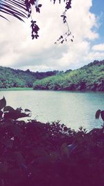 Scenic view of lake against cloudy sky
