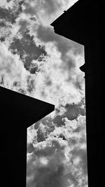 Low angle view of building against cloudy sky