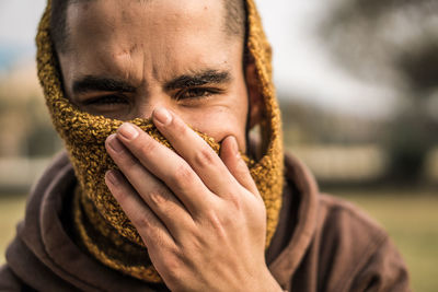 Close-up portrait of man covering face