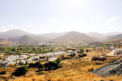 Scenic view of landscape and houses against sky