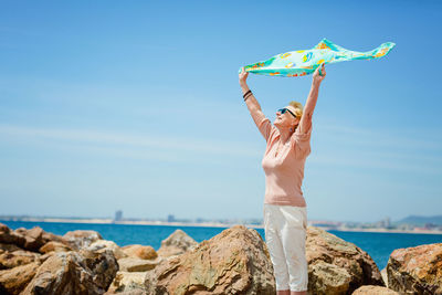 Happy mature woman smiling and having fun at beach