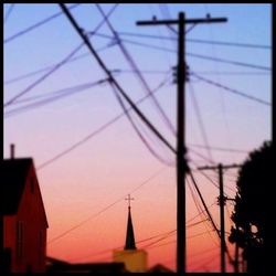 Low angle view of electricity pylon against sky