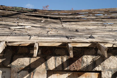 Low angle view of damaged building bathhouse at hot springs against sky