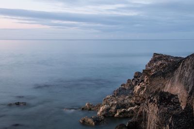 Scenic view of sea against cloudy sky