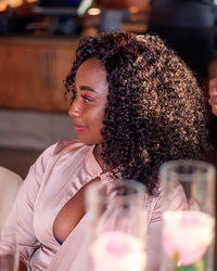 Side view of young woman drinking glass of wine 