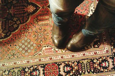 Low section of woman standing on tiled floor