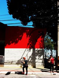 Full length of man standing by tree in city