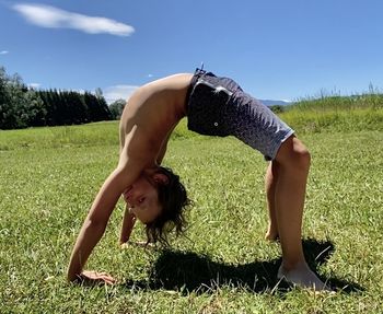 Full length of woman relaxing on field