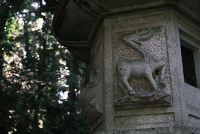 Low angle view of angel statue in cemetery