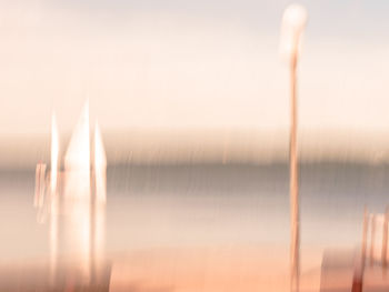 Close-up of illuminated lamp against sky