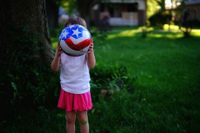Girl holding stars and stripes soccer ball