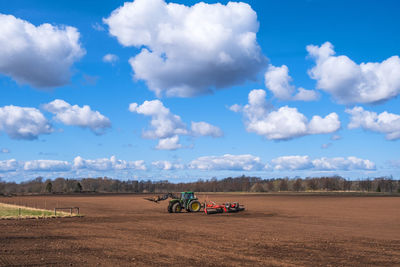 Tractor with a cultipacker on a field